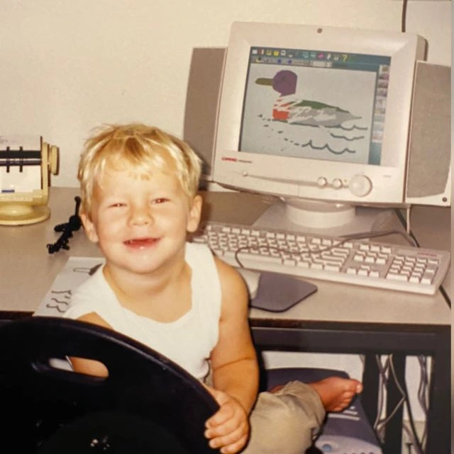 Joshua Kruter as a child sitting at a computer.